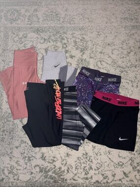 Bundle of Nike DriFit capris, Under Armour leggings, and Nike DriFit yoga shorts